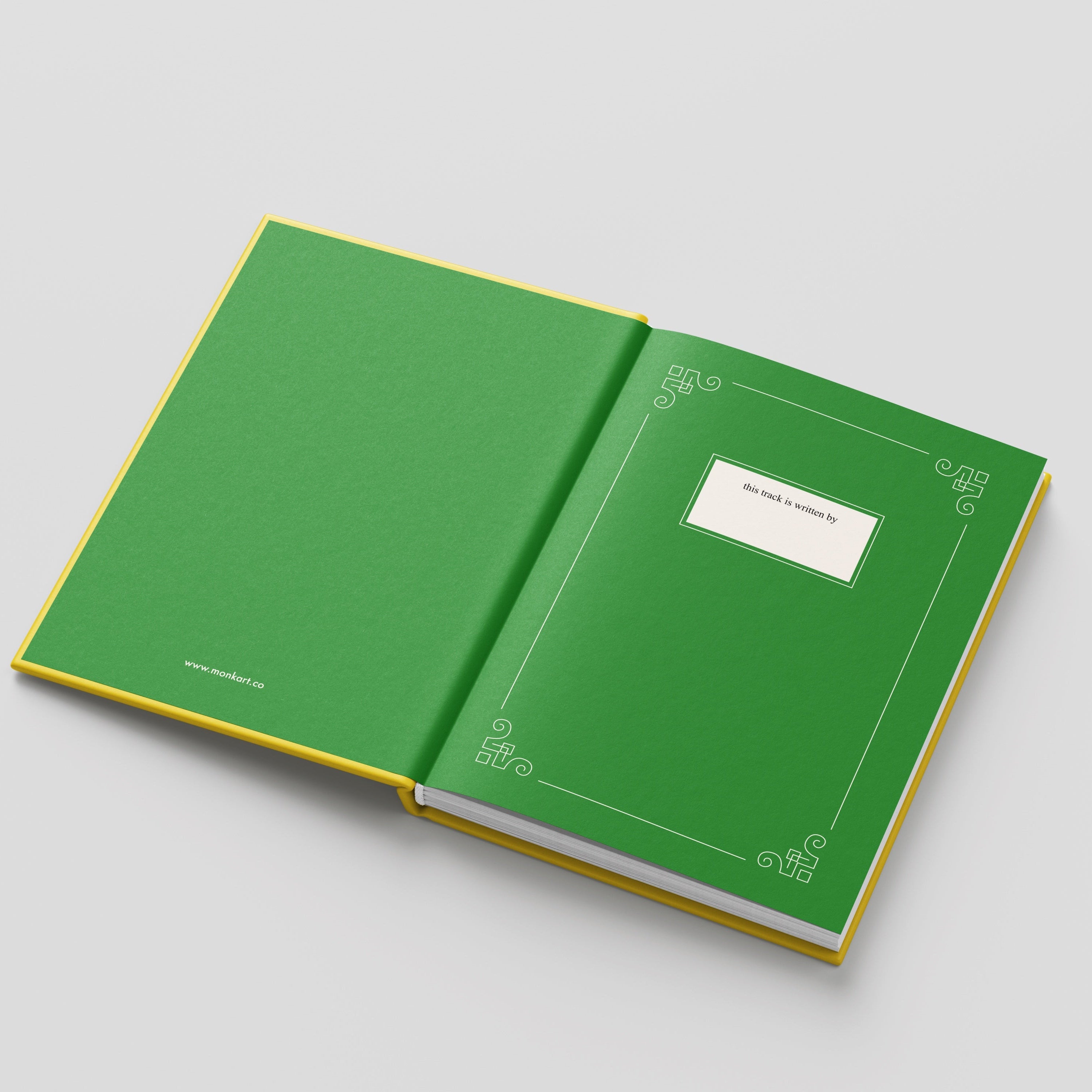 Open green book with decorative patterns on a light gray background