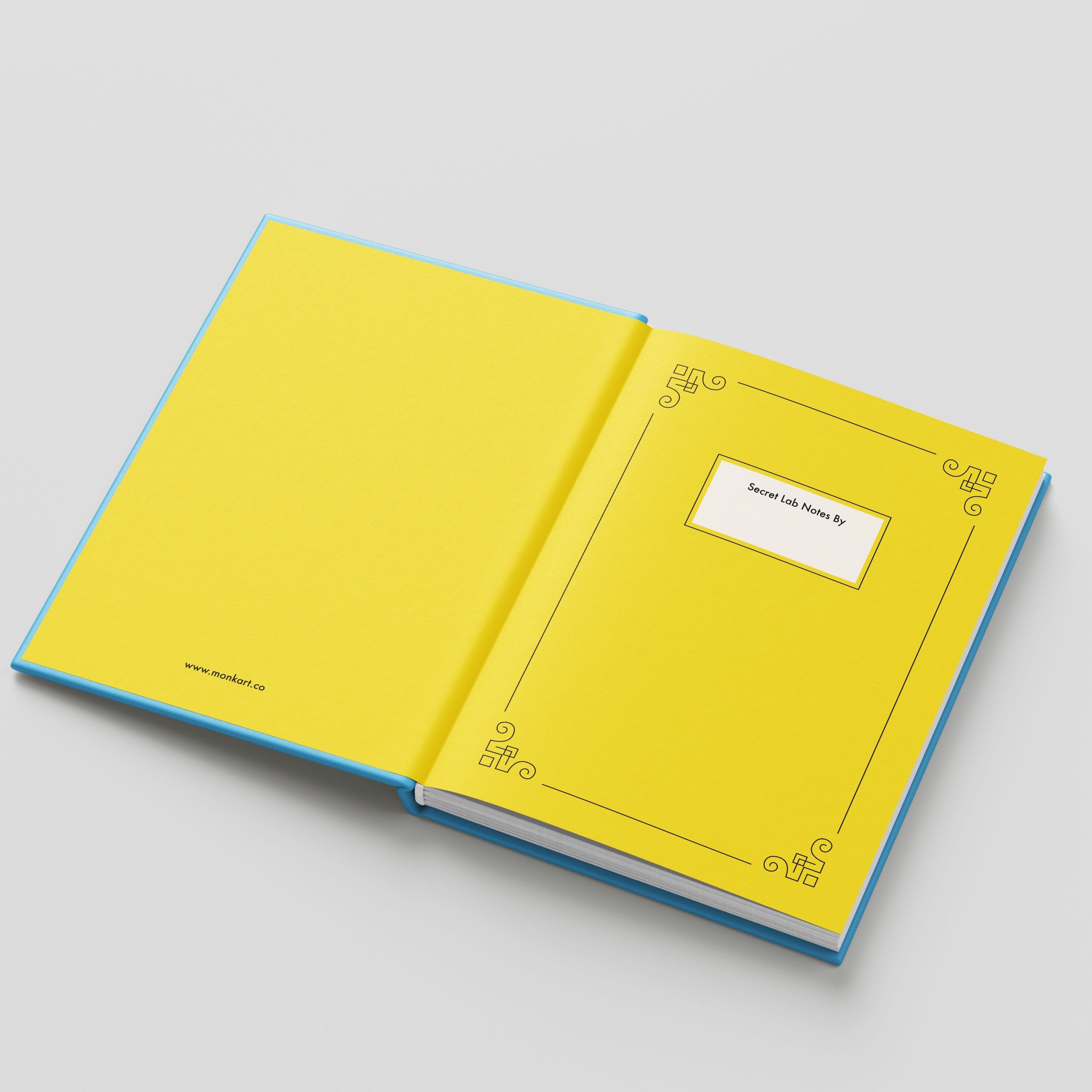Open yellow notebook with blue edges on a light gray background